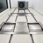 Chassis dynamometer test cell with vehicle on rolls