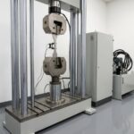 Servo-hydraulic fatigue test frame with specimen in hydraulic grips