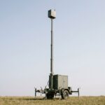Trailer-mounted telescopic mast extended to height carrying a generic payload
