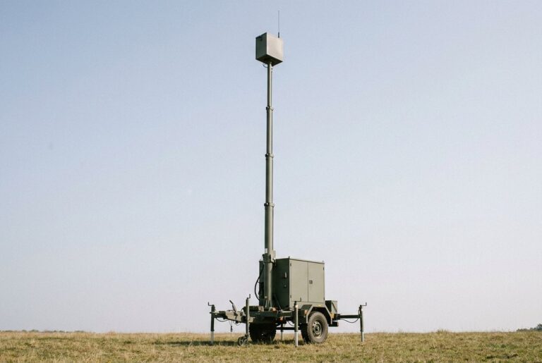 Trailer-mounted telescopic mast extended to height carrying a generic payload